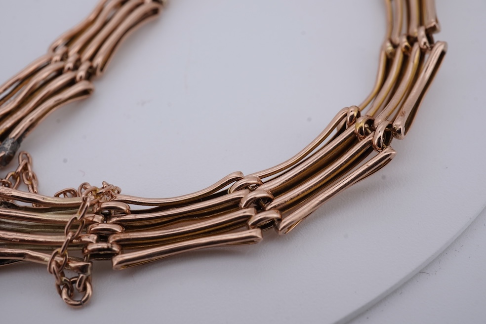 An early 20th century yellow metal gate link bracelet, with heart shaped padlock clasp on safety chain, stamped '9', approx. 18cm, 9.2 grams. Condition - poor